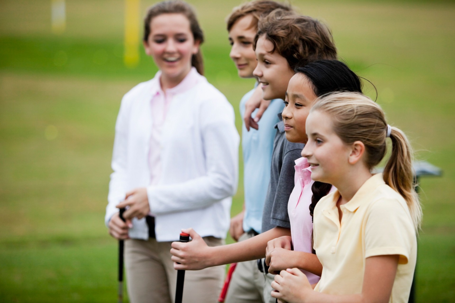 Group of children on golf driving range