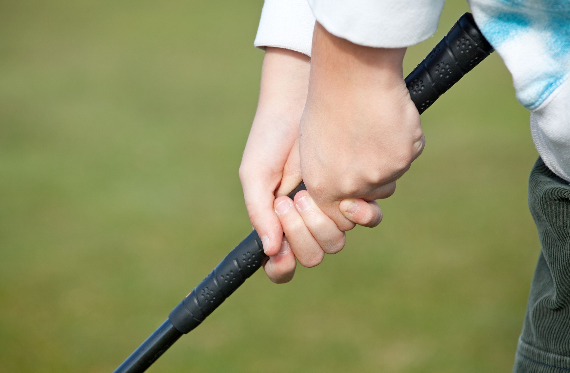 Closeup of Junior Gripping Golf Club